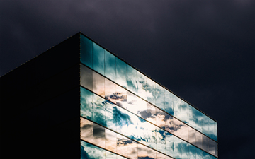 Cloudy_sky_reflected_on_glass_building_21_s.jpg