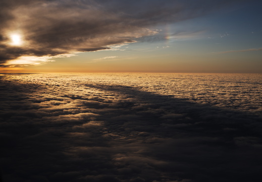 Cloudscape with  sundog parhelion at sunset from plane